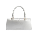 A small silver metallic vegan leather rectangle shaped top handle bag.