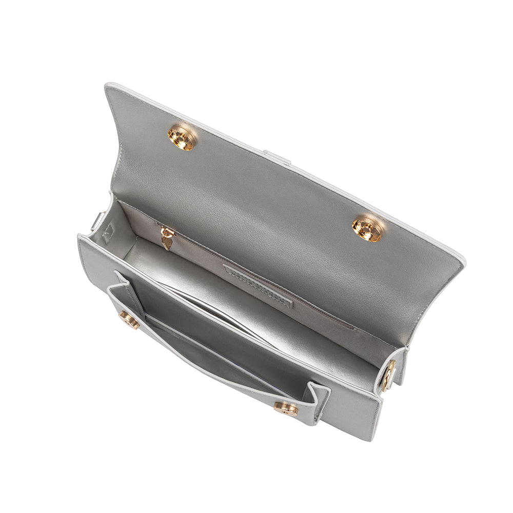 A small silver metallic vegan leather rectangle shaped top handle bag.